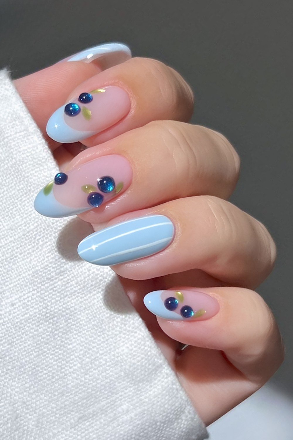 Light blue French nails with cat eye blueberry accents