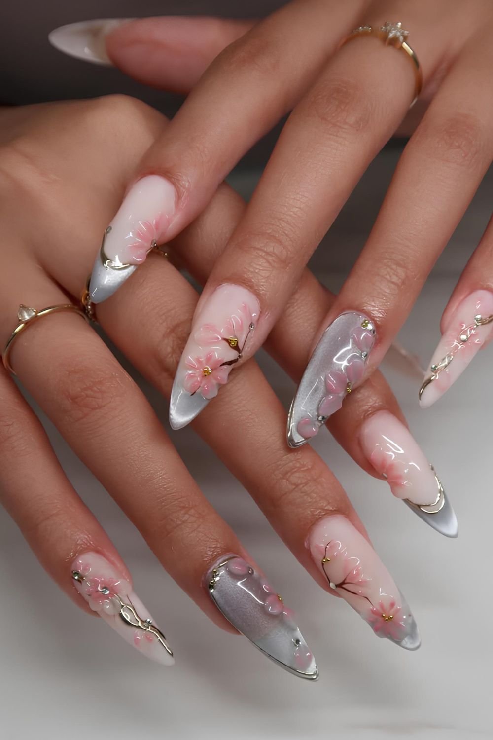 Light blue cat eye nails with pink cherry blossom 3D design
