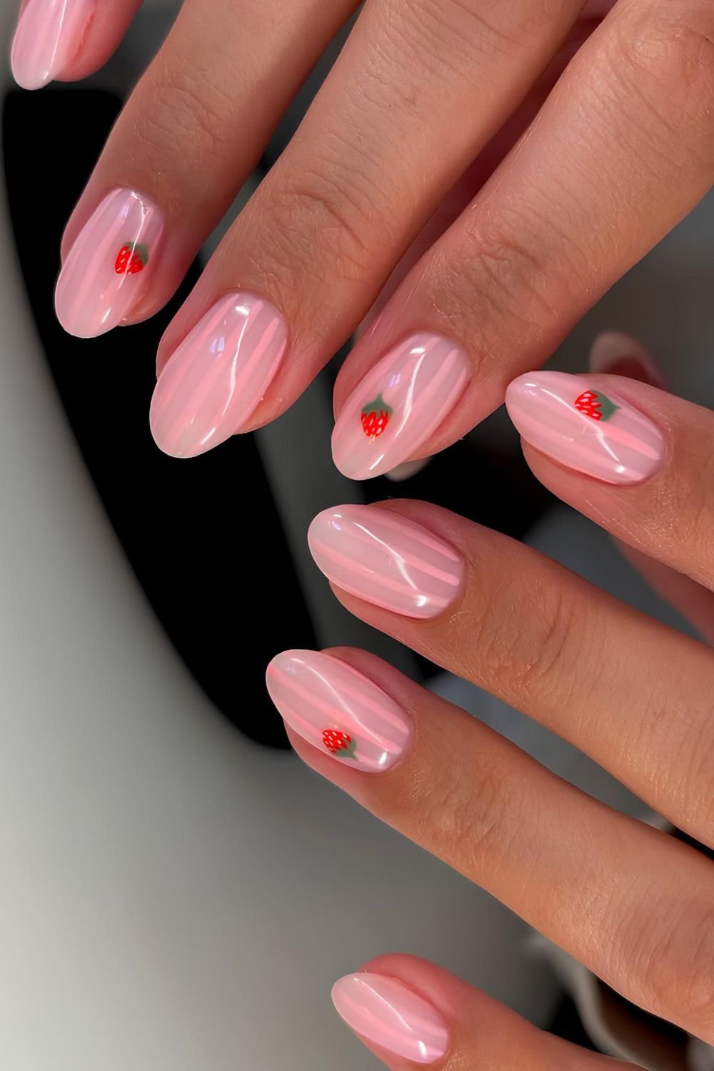 Milky pink and light pink striped nails with strawberries