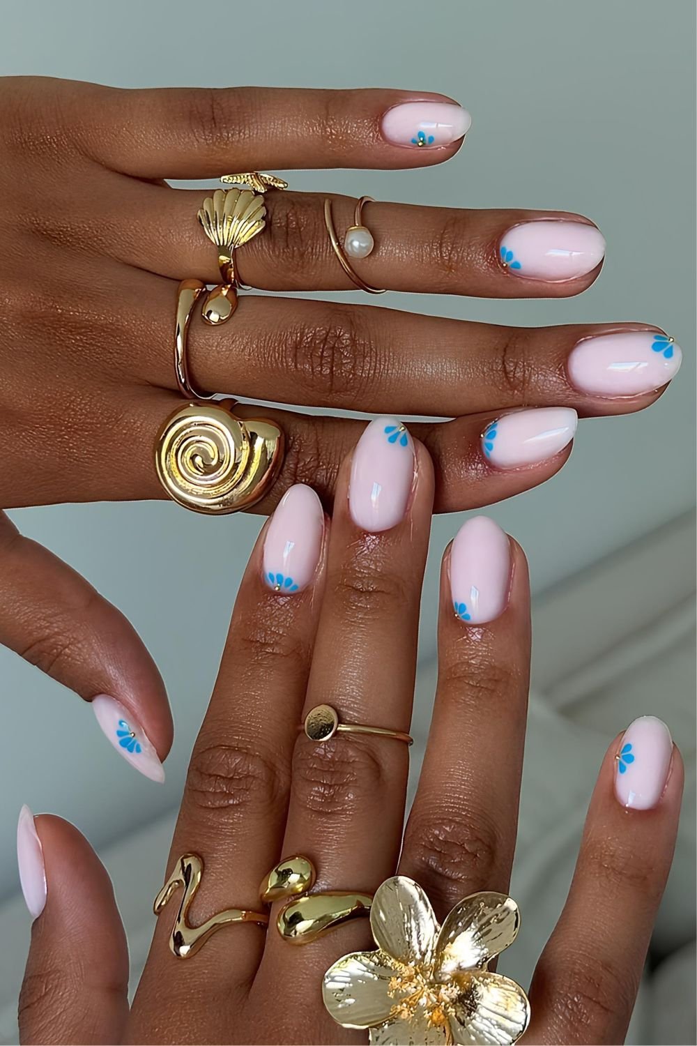 Milky pink nails with floral petal design