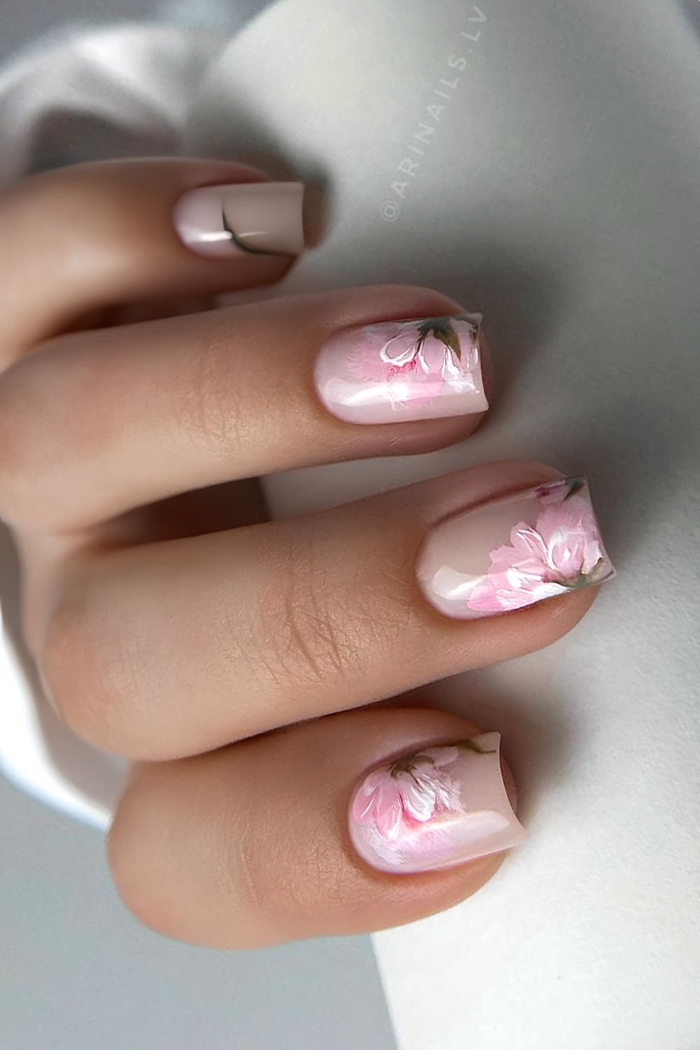 Milky white nails with half floral cherry blossom design in brushstroke technique