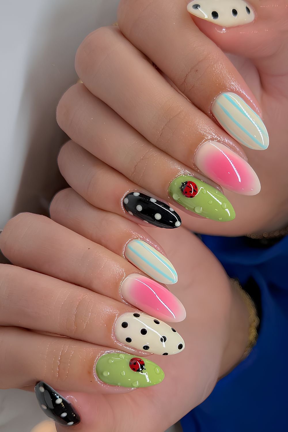 Mix and match mani with polka dots, stripes, aura effect and ladybug and dew-drops on a green