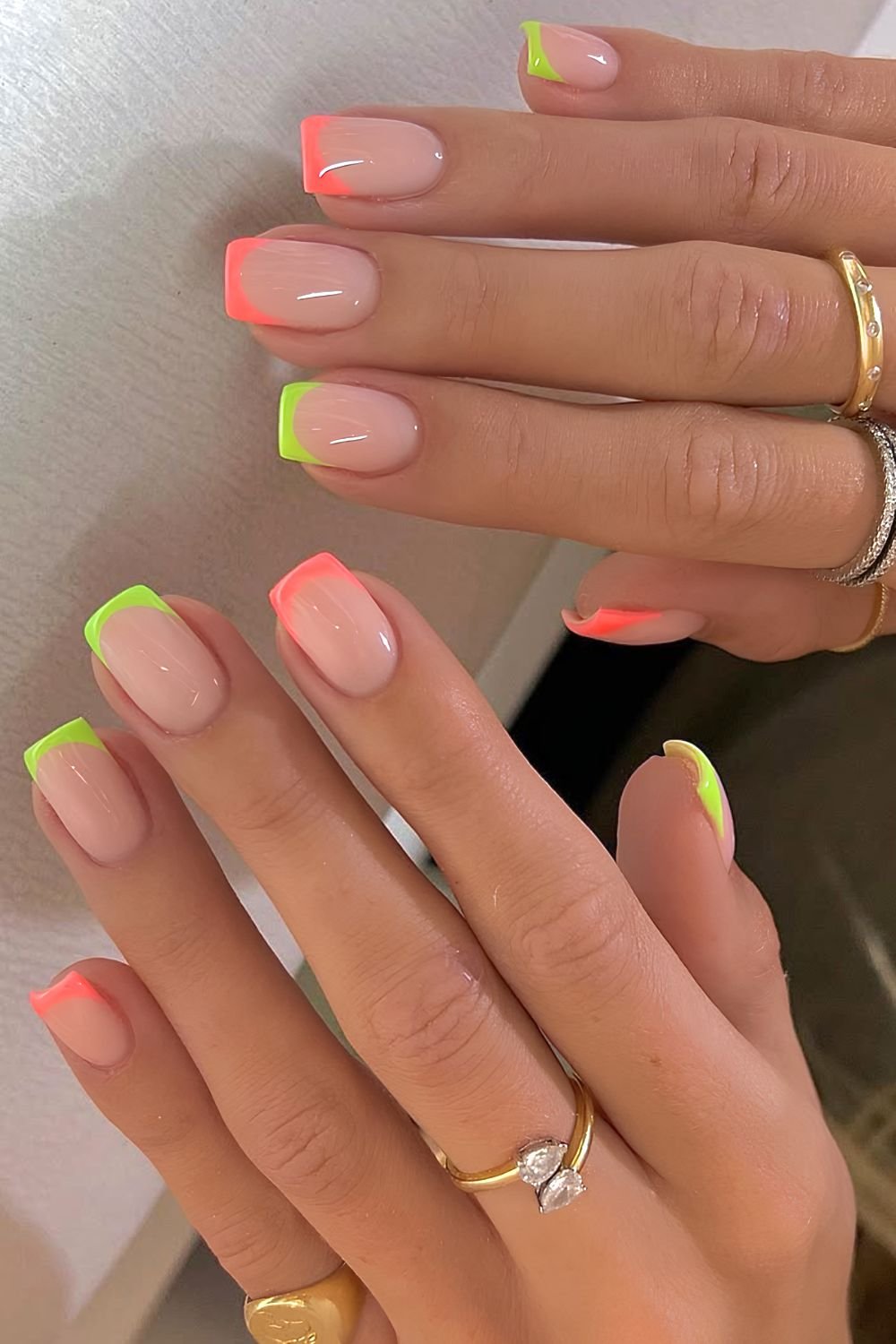 Neon pink and green French tip nails