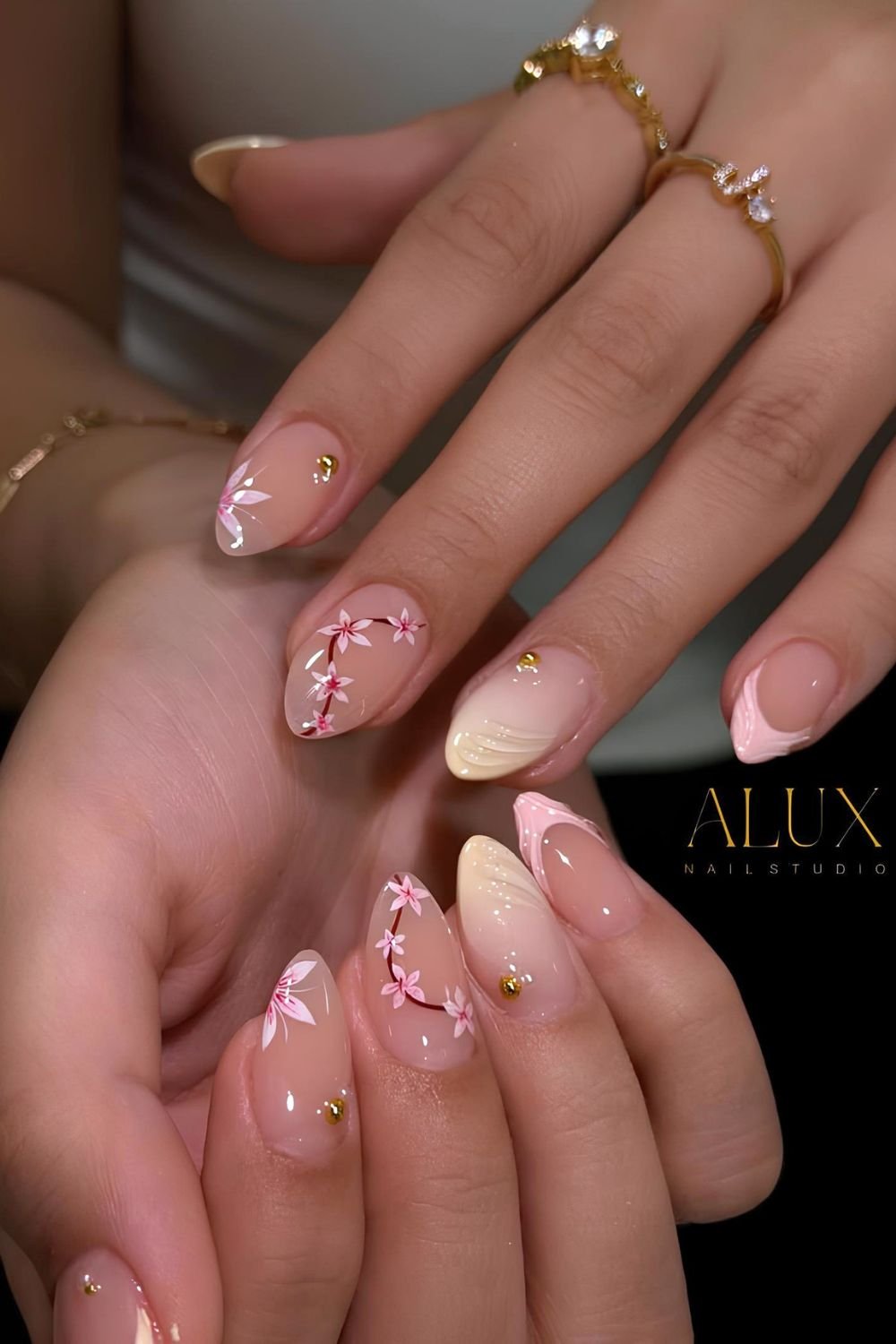 Neutral nails with textured yellow and pink tips and cherry blossom accents