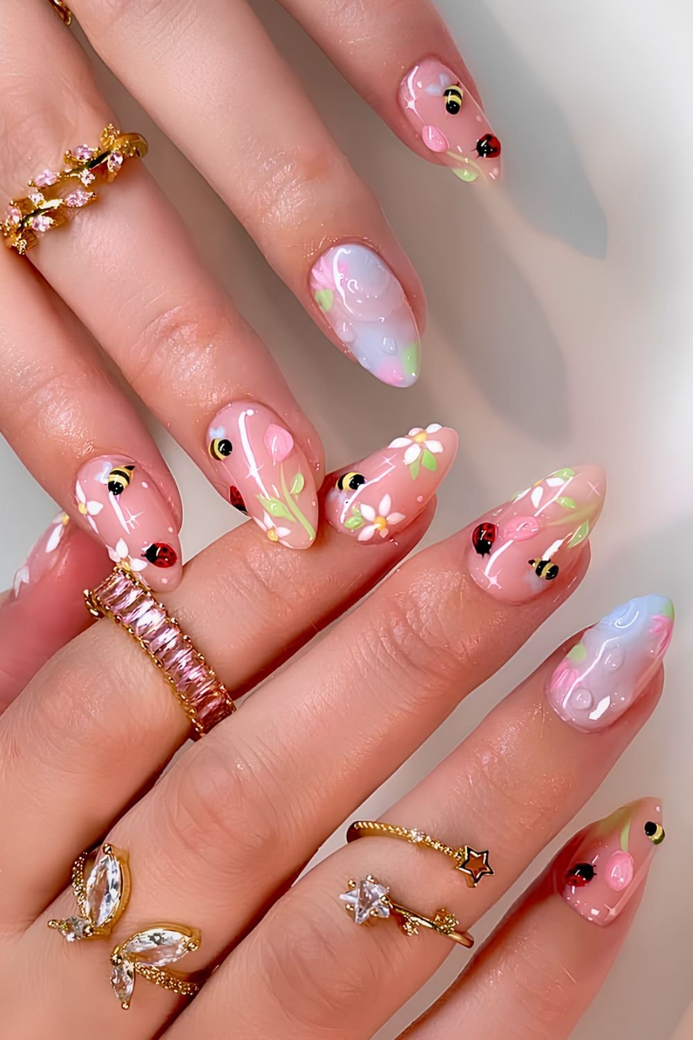 Pastel floral nails with bees and ladybugs