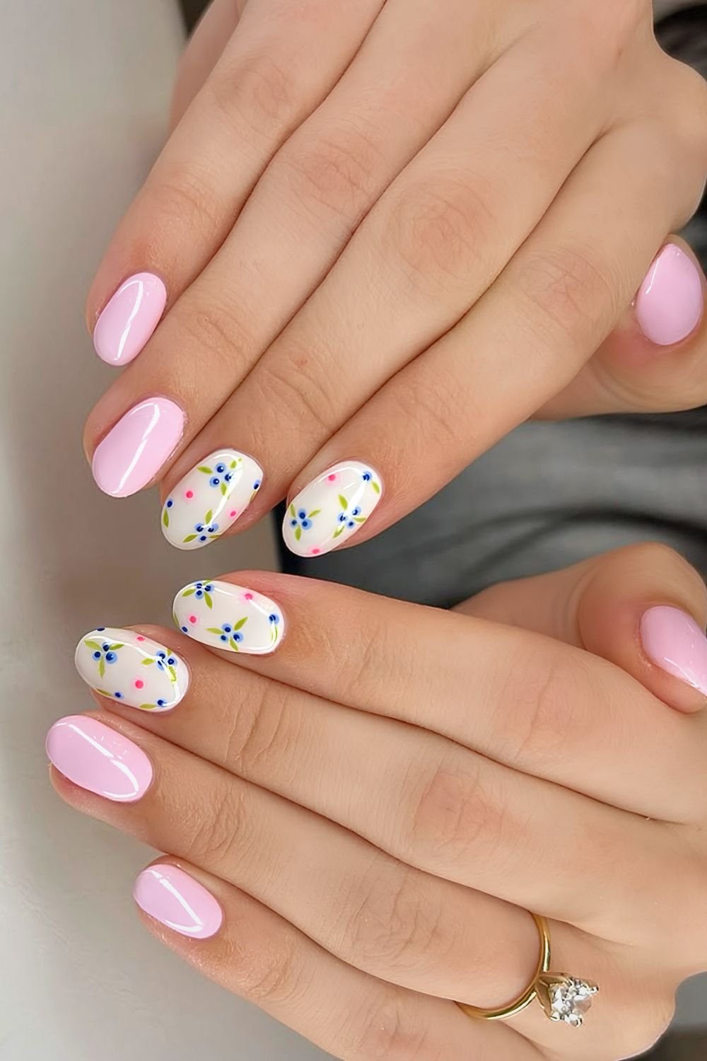 Pastel pink and white nails with blueberry and floral accents