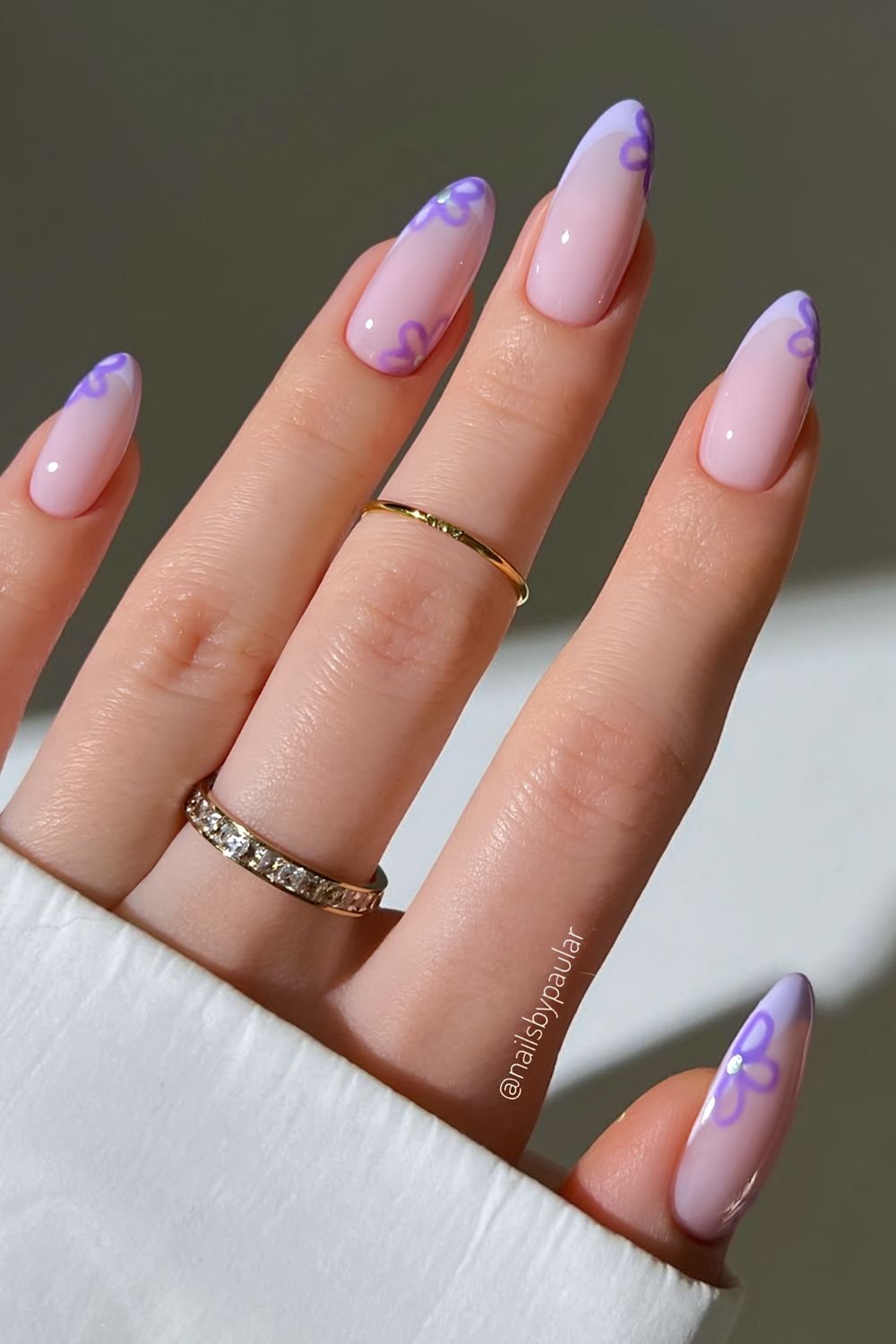 Pastel purple French tips with dark purple floral nail art