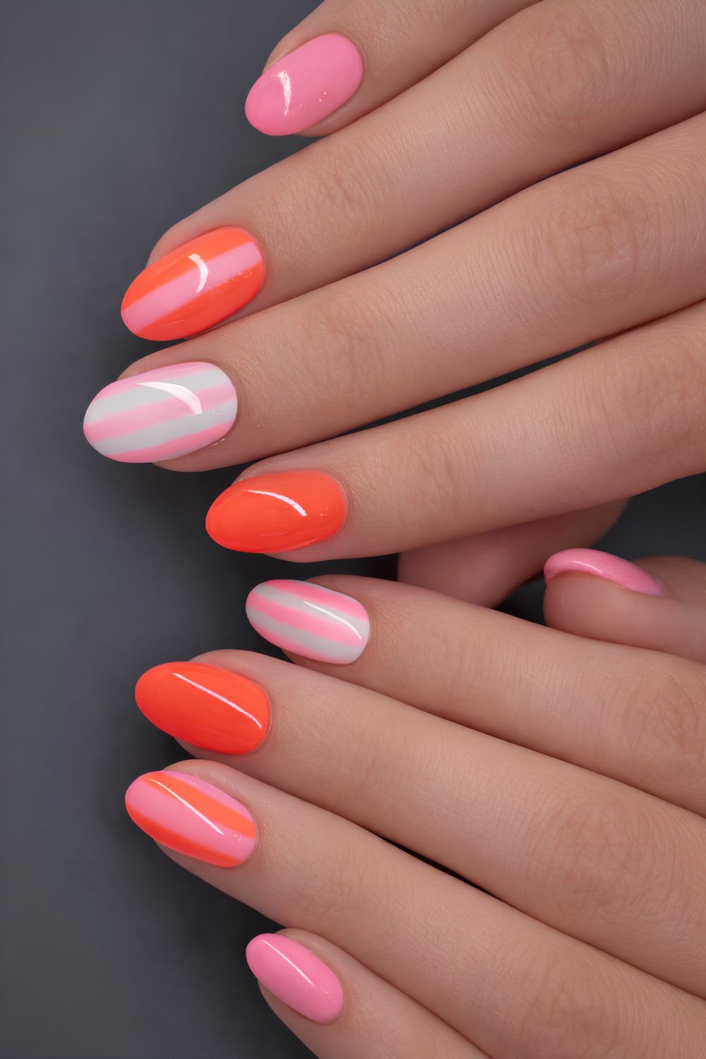 Pink and neon orange stripped nails