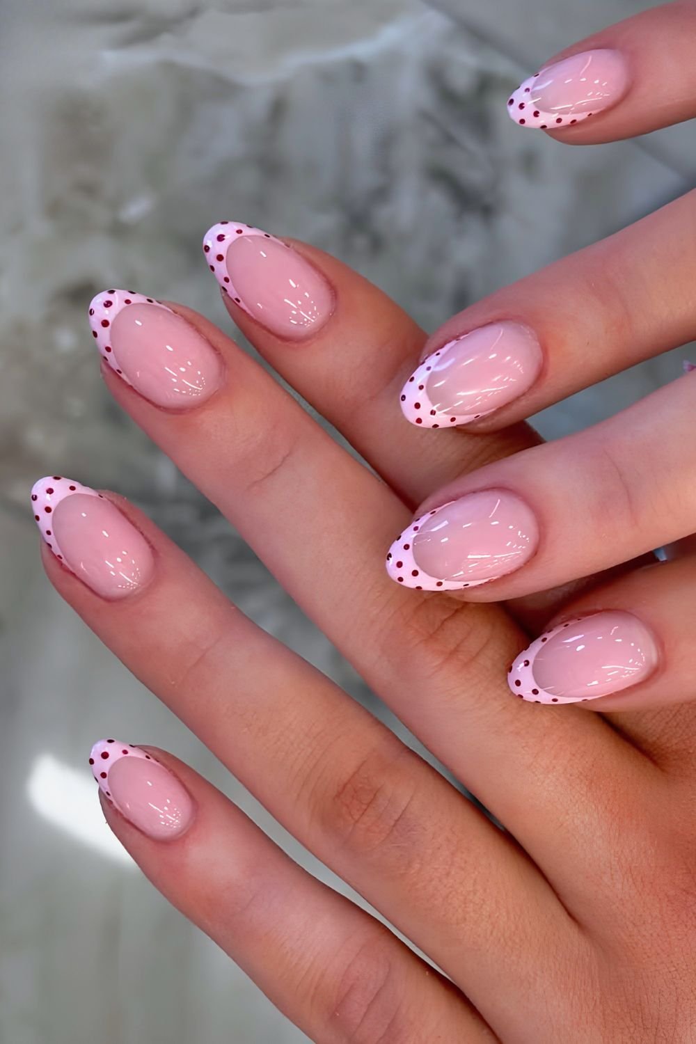 Pink with dark red polka dot French tip nails