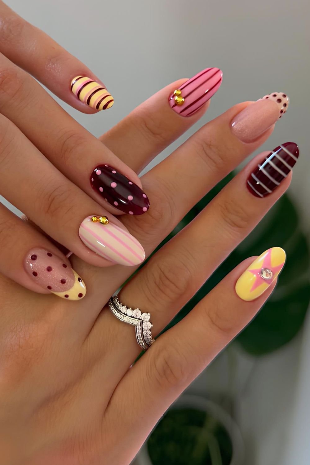 Polka dots and stripesnails in yellow pink and dark red