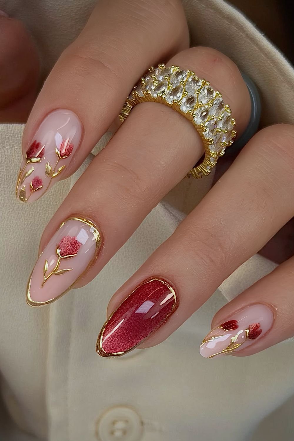 Red cat eye tulip nails with golden chrome accents