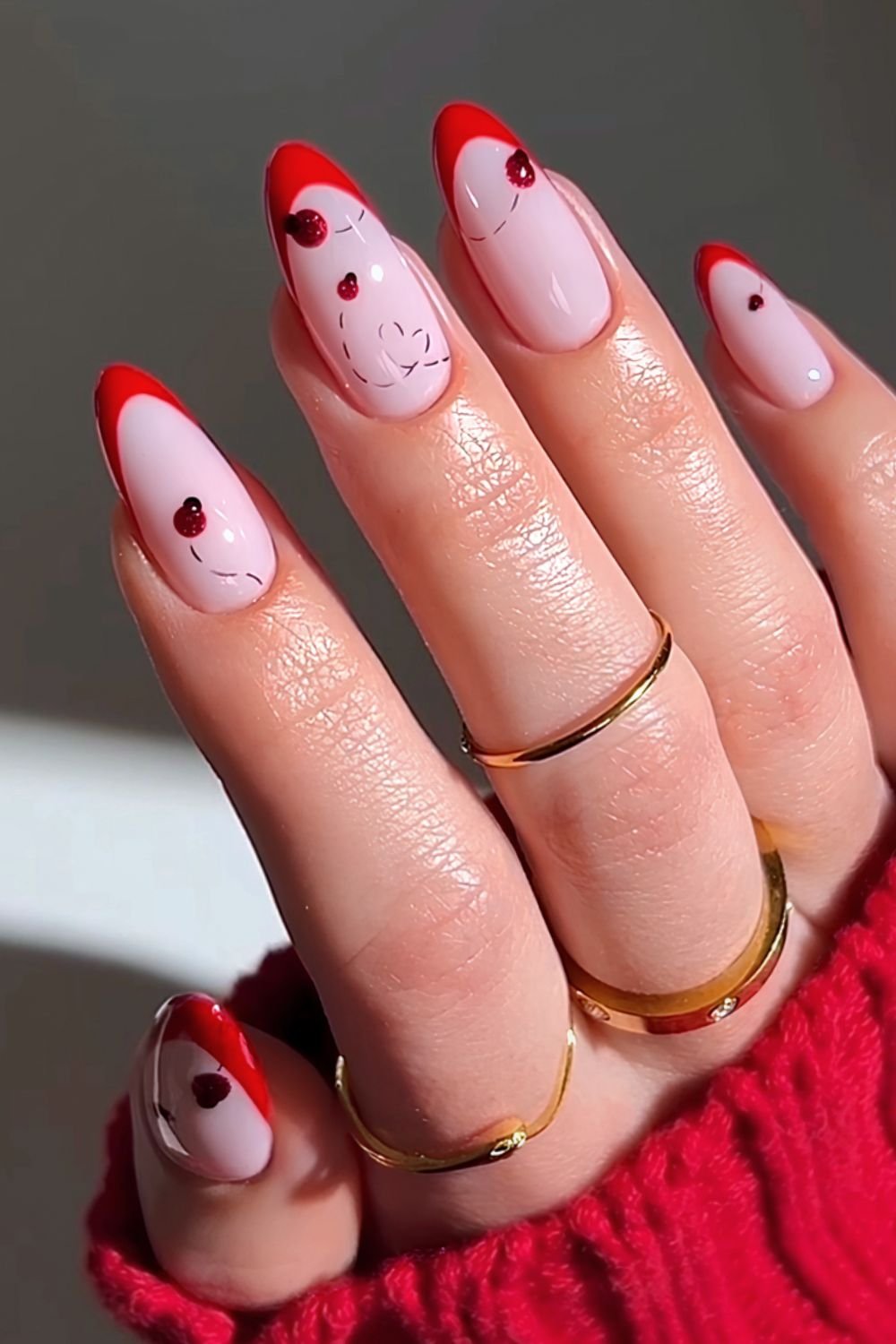 Red french tips with ladybug heart trail design