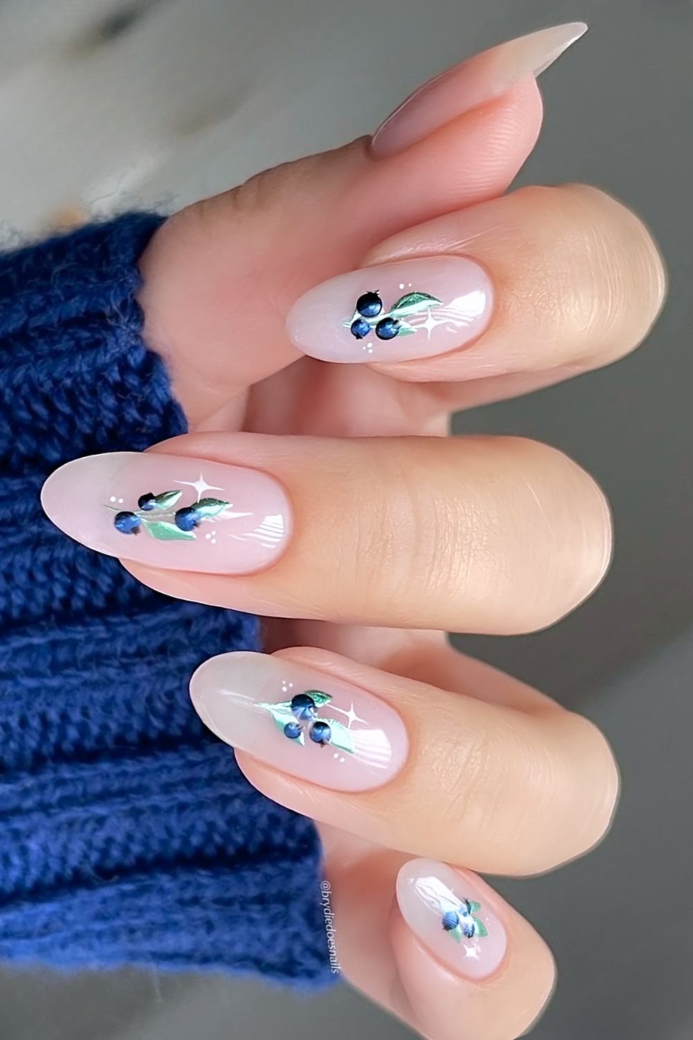 Sheer milky pink nails with chrome blueberry designs