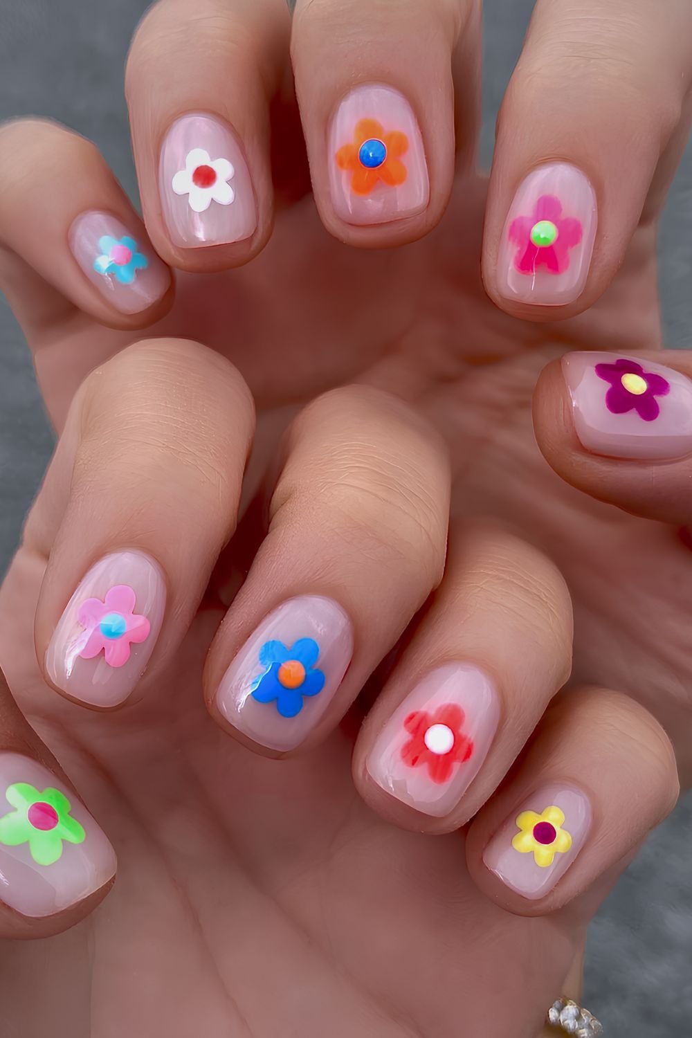 Short neutral nails with colorful flower design