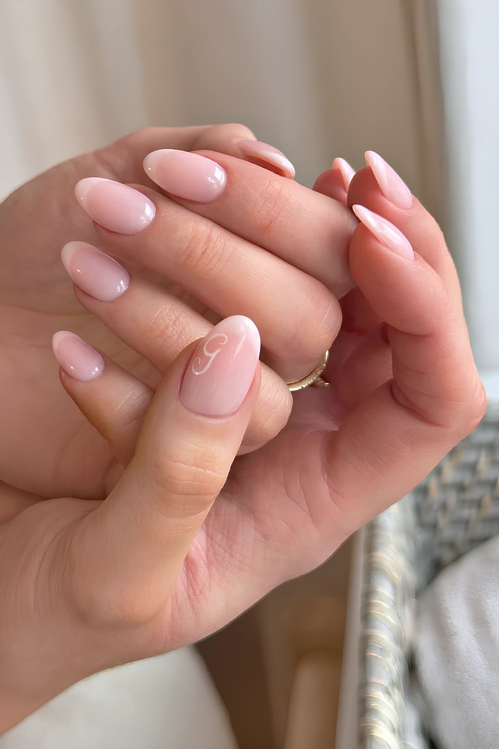 Soft white French manicure with a letter accent