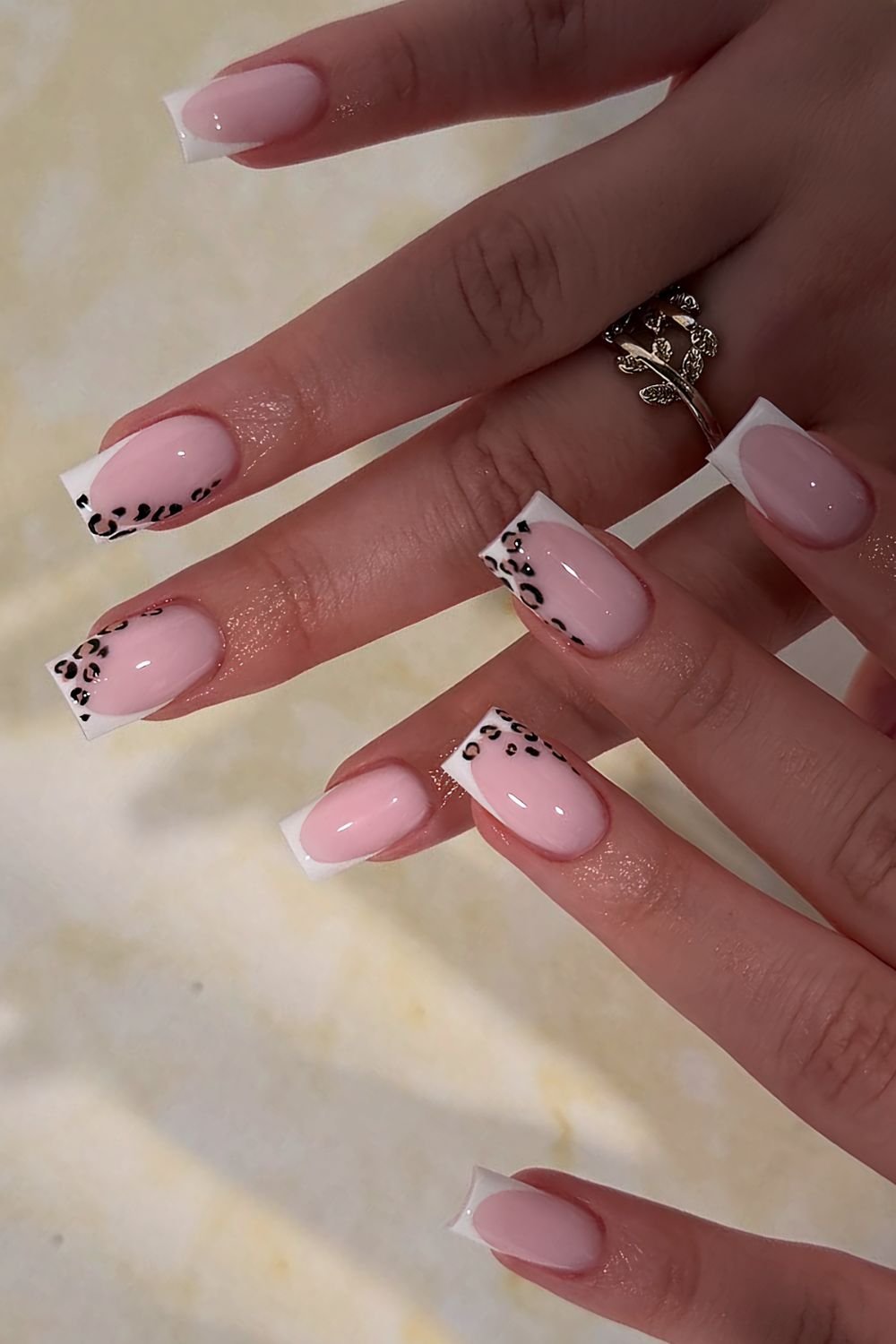 White French tip nails with leopard print accents