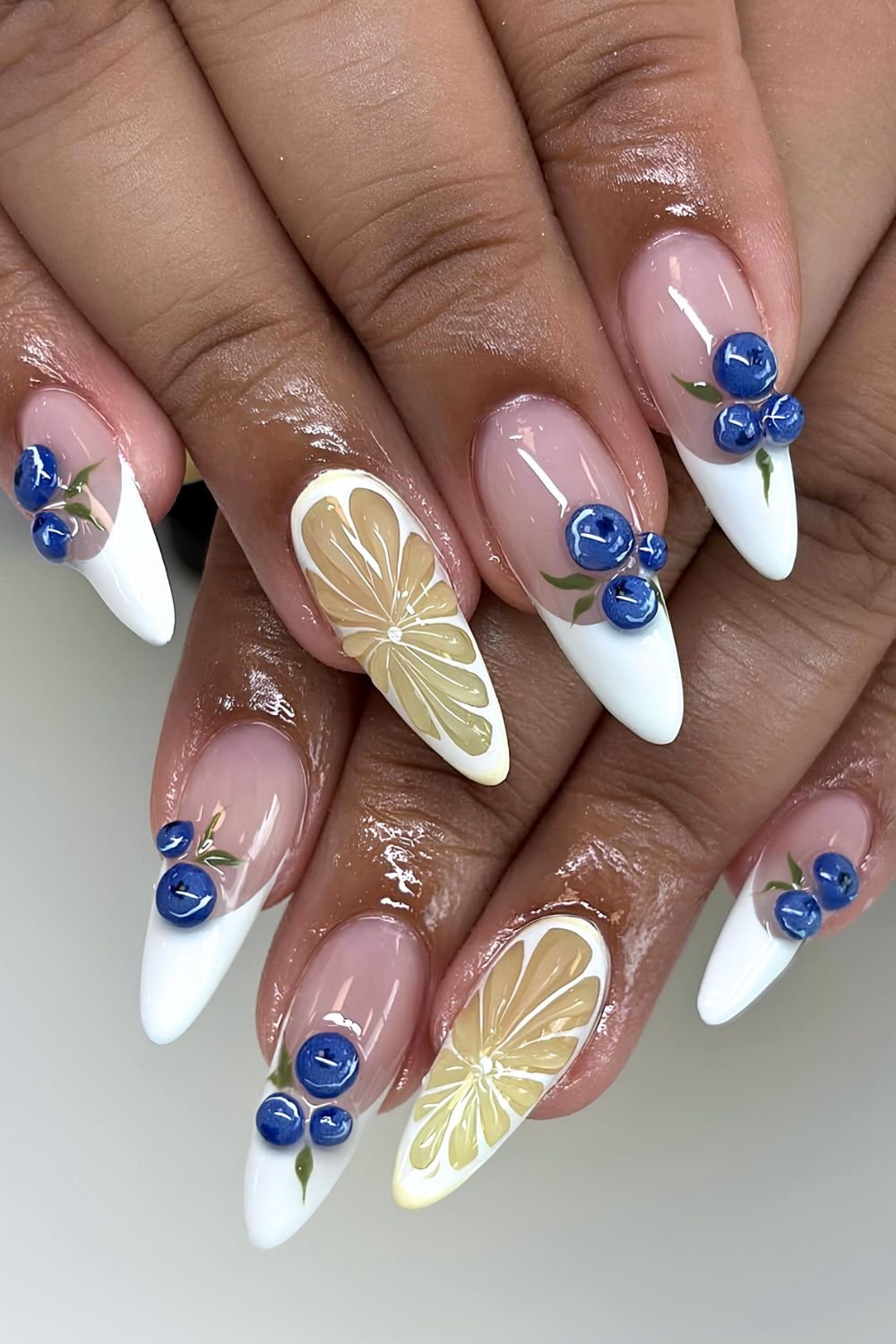 White French tips with blueberry and lemon slice accent nails