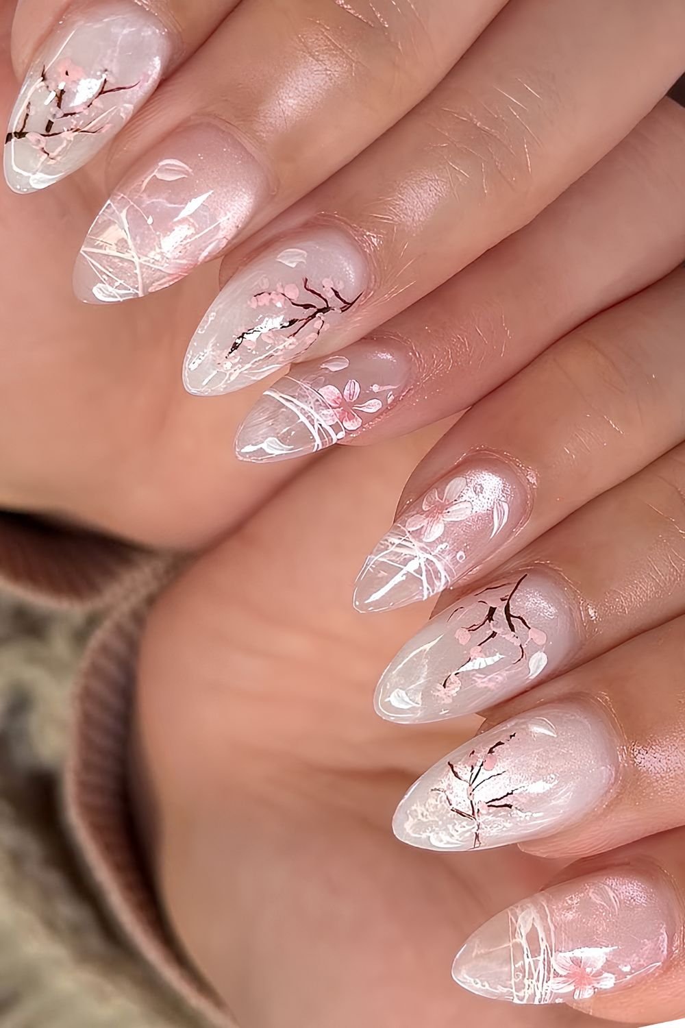 White cat eye nails with cherry blossom branch and floral design