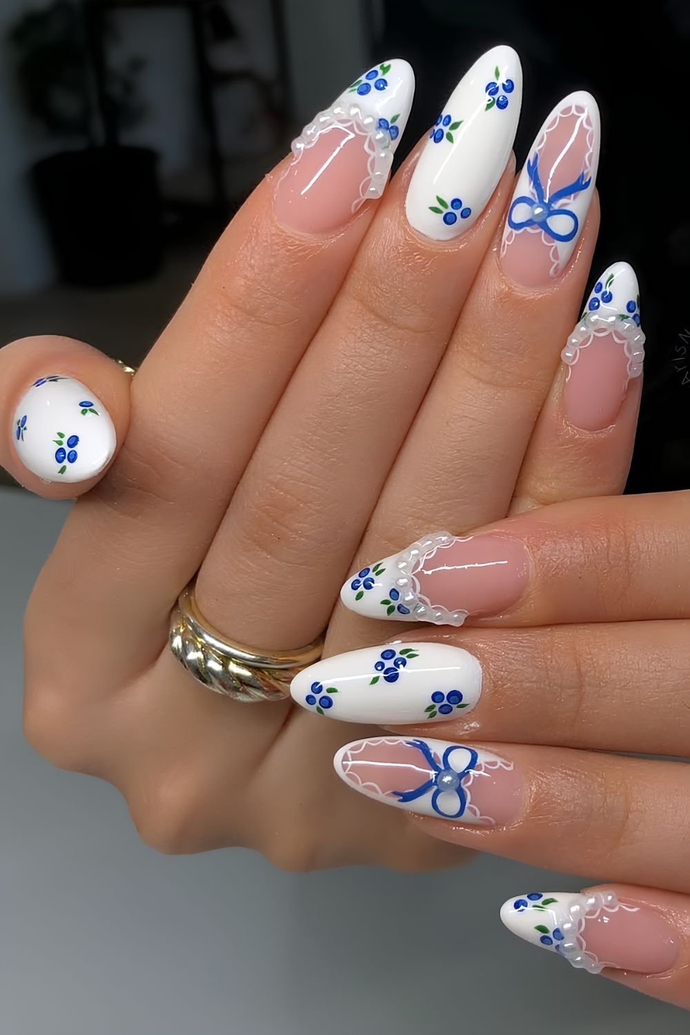 White nails with blueberry, lace, pearl and bow designs