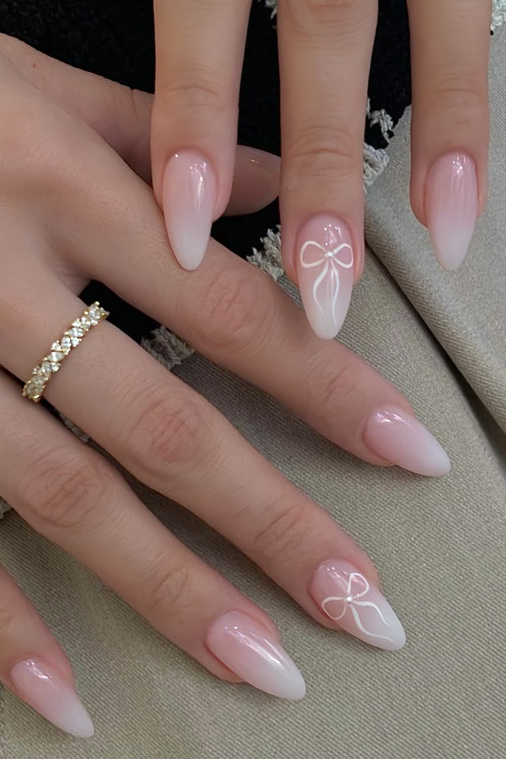 White ombre nails with pearl centered white bow accents
