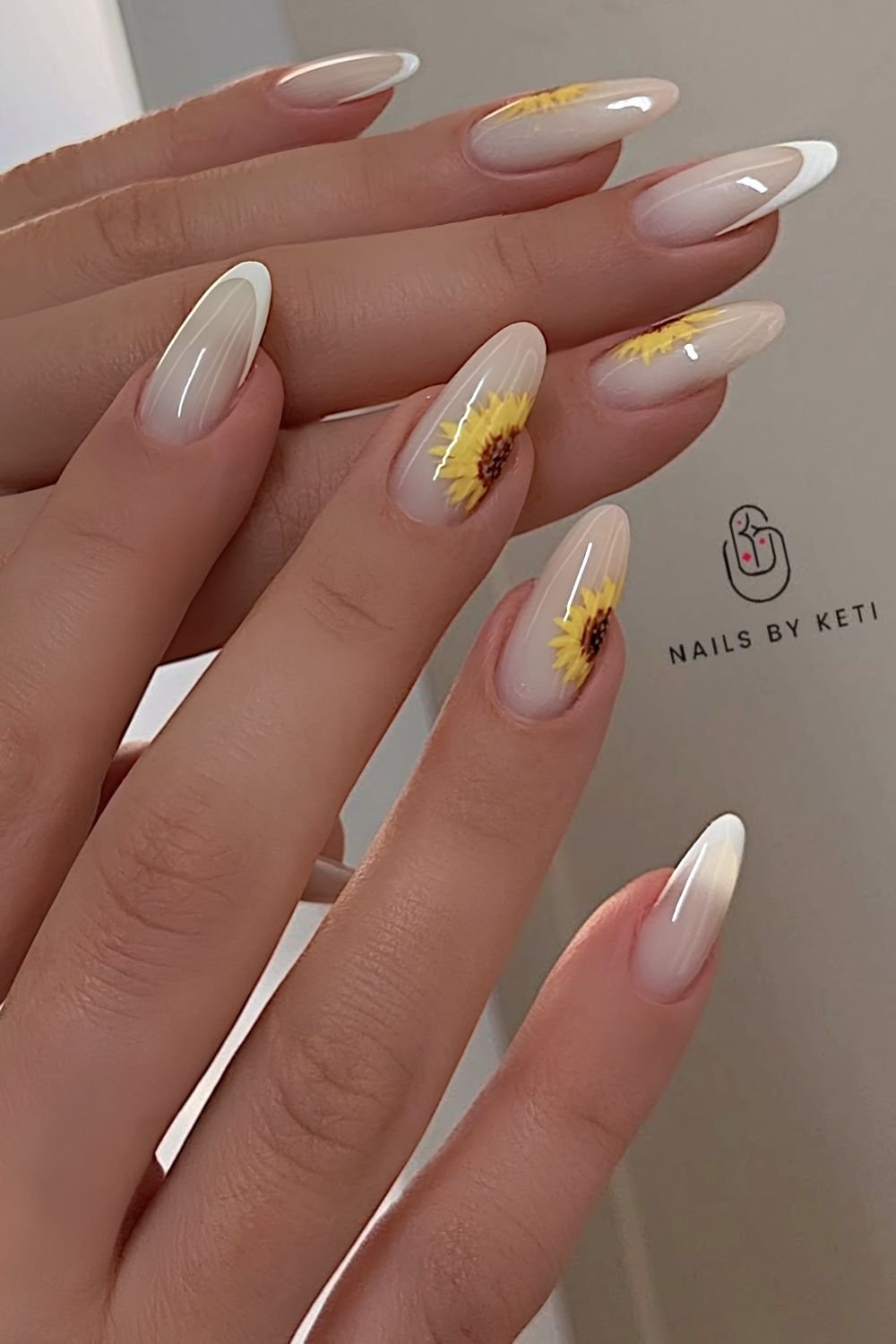 White on white French tips with half sunflower design