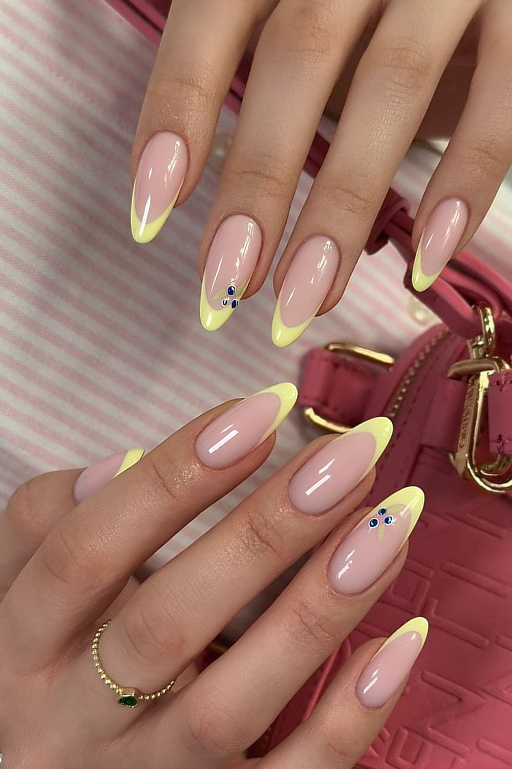 Yellow French tip nails with blueberry accents