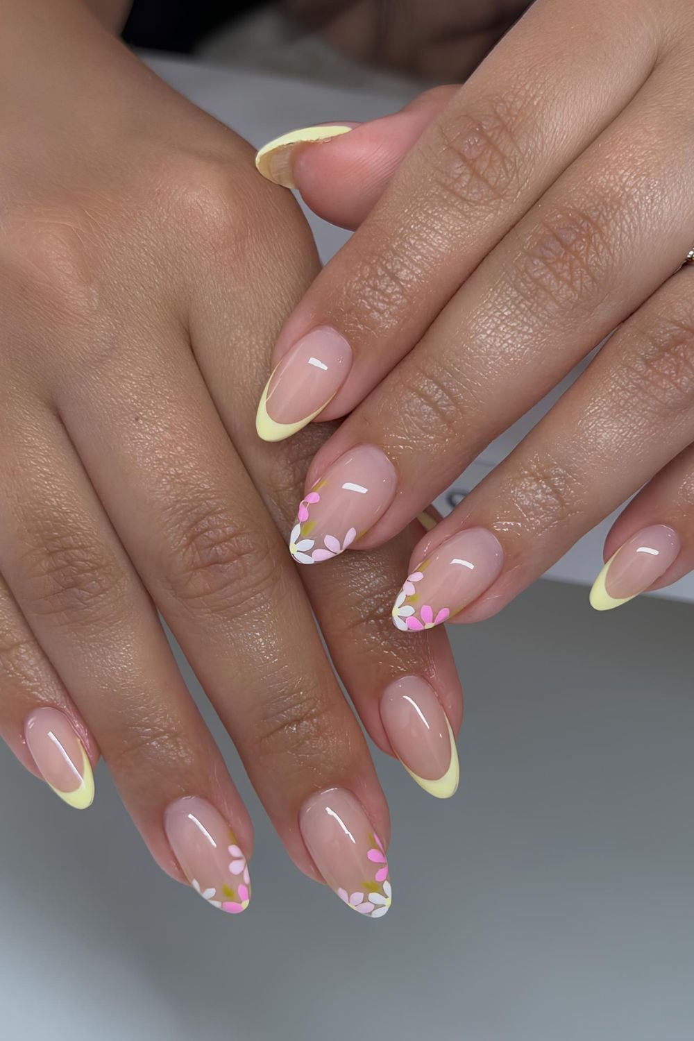 Yellow French tip nails with pink floral french accents