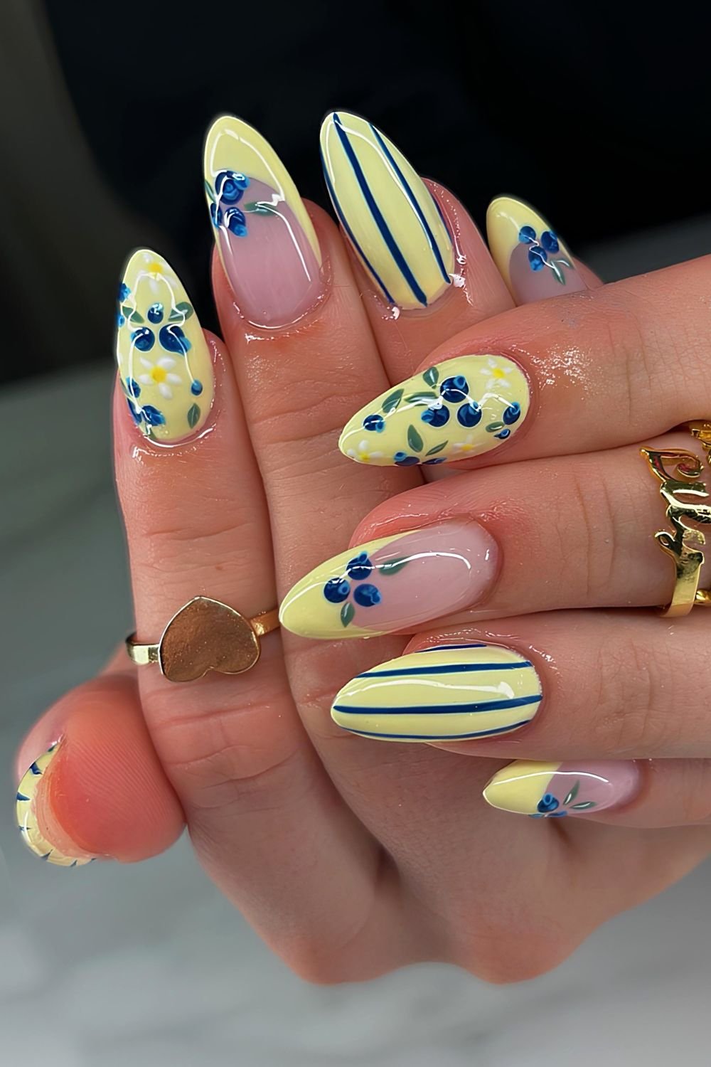 Yellow and blue striped nails with blueberry accents