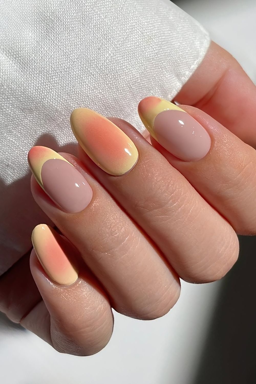 Yellow and coral aura nails with French tip accents