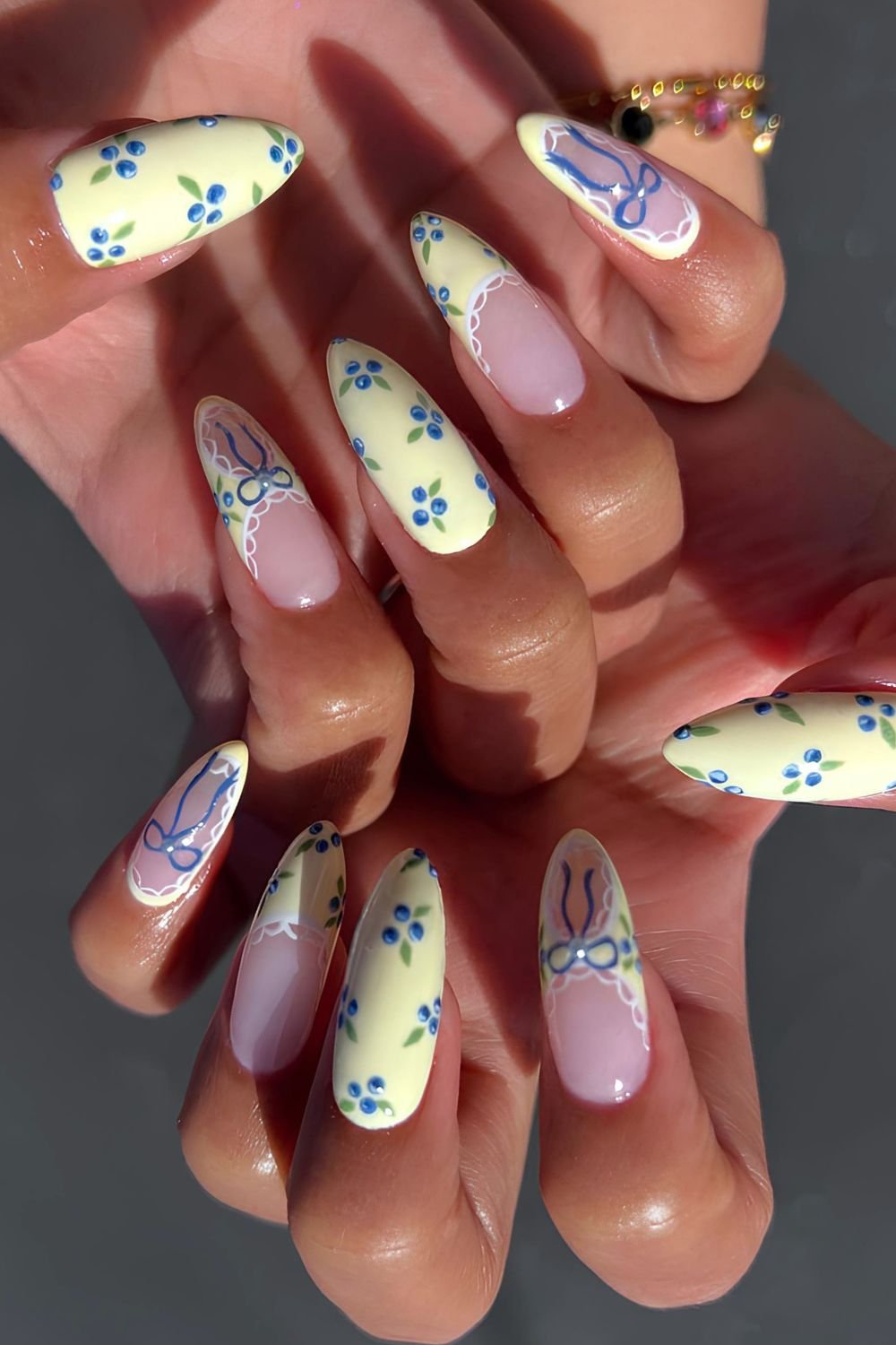 Yellow nails with blueberry, bow and lace design