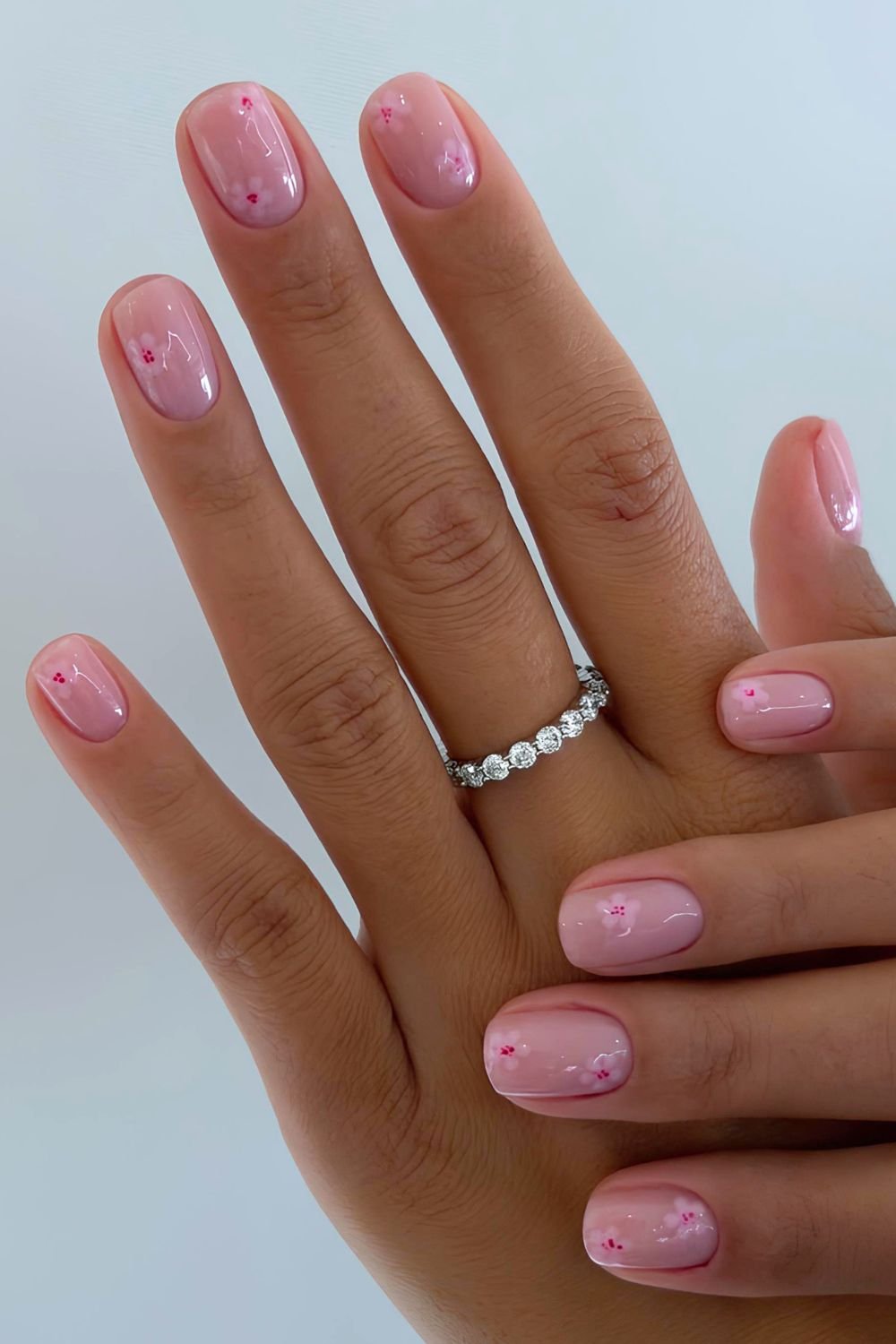 short glossy pink nails with pink cherry blossom flowers