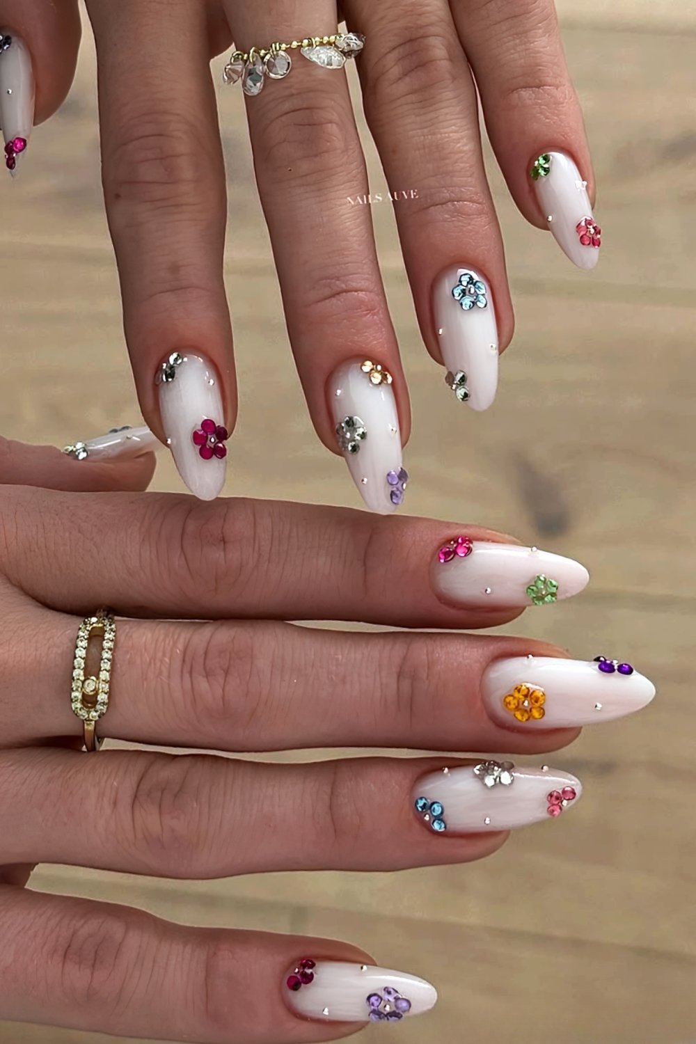 Colorful gem floral nails on a white base