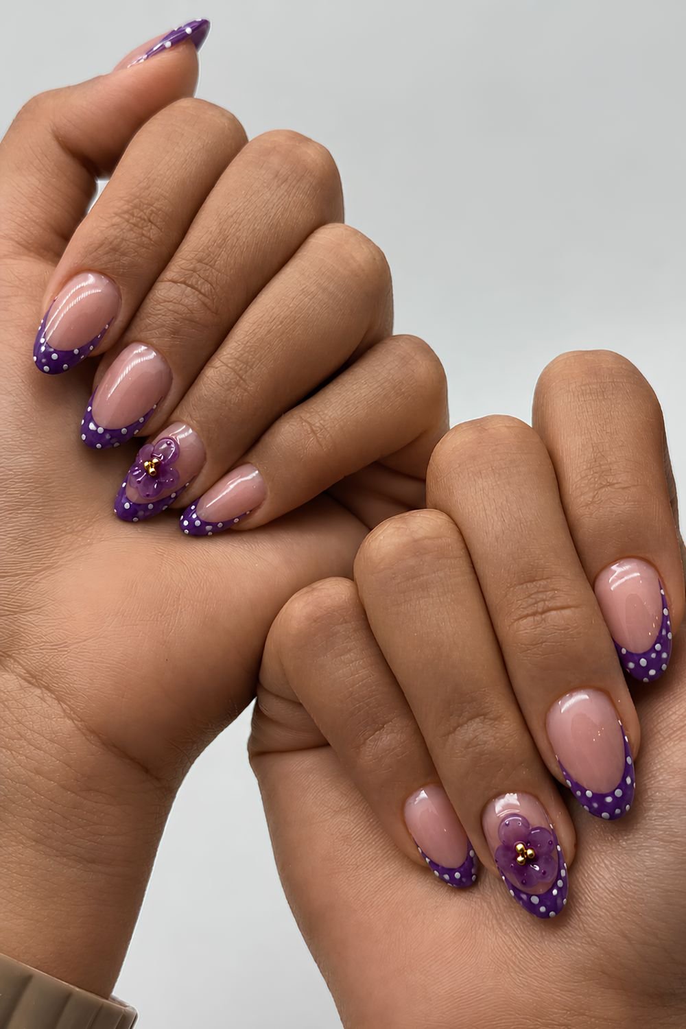 Dark purple French tips with white polka dots and 3D flower accents