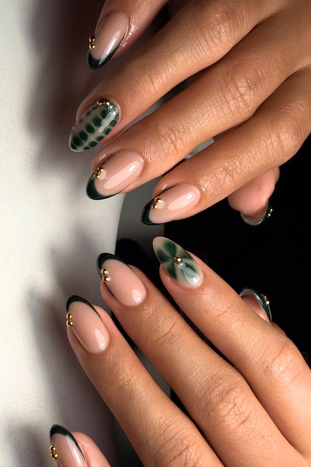 Emerald green nails with blooming gel accents and golden studs