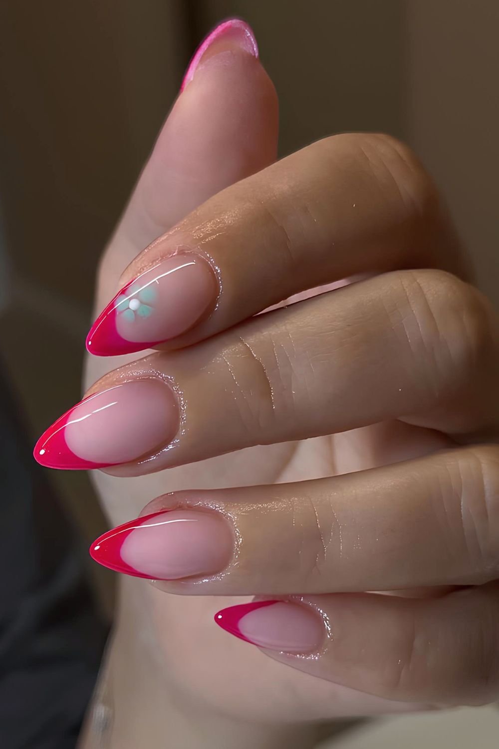 Hot pink French nails with blue flower accents