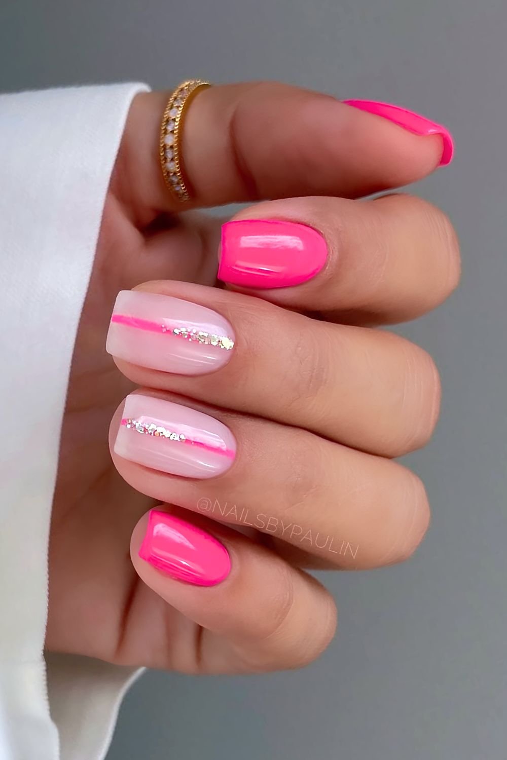 Hot pink and milky pink nails with glittery line accent