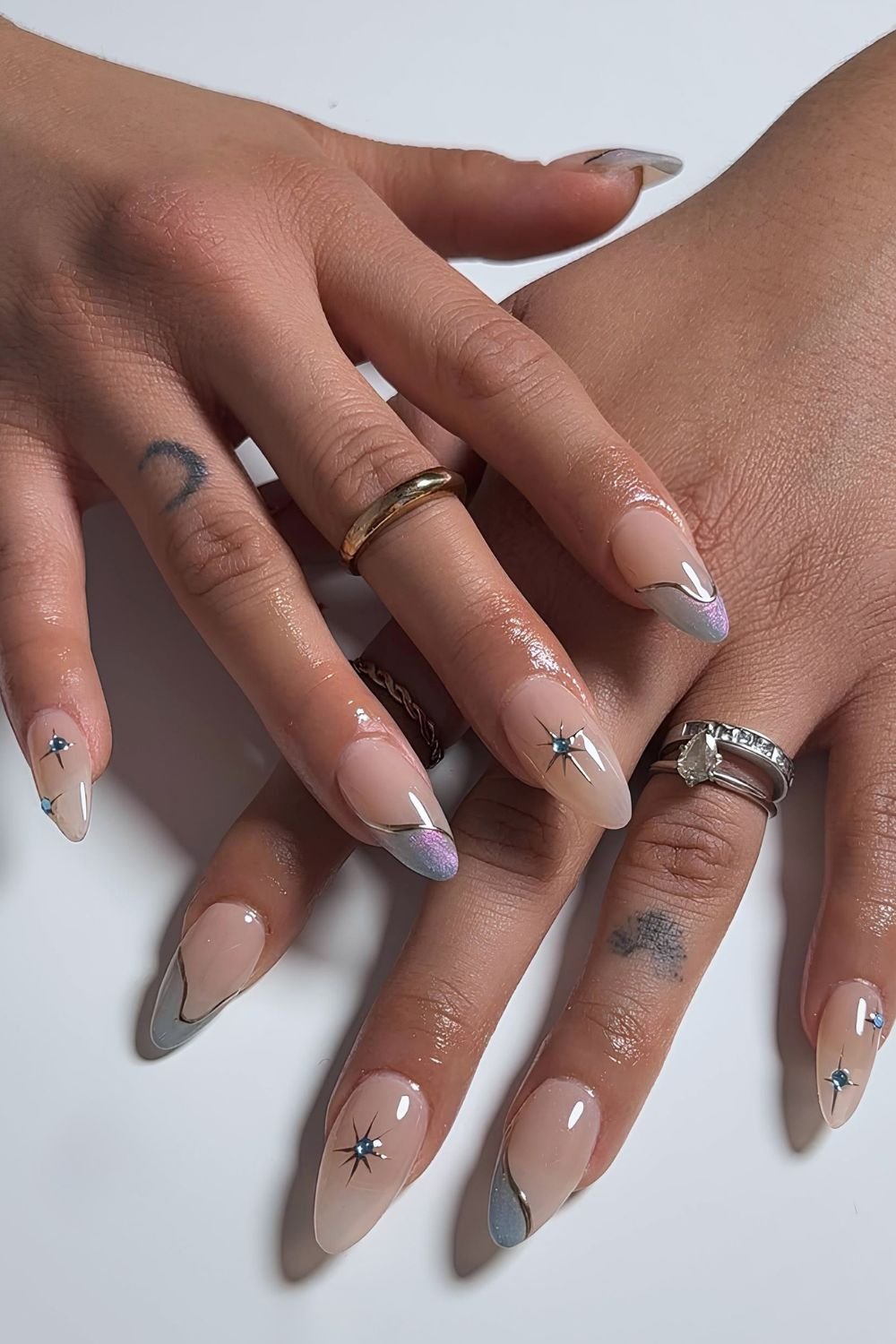Iridescent blue abstract French nails with celestial design