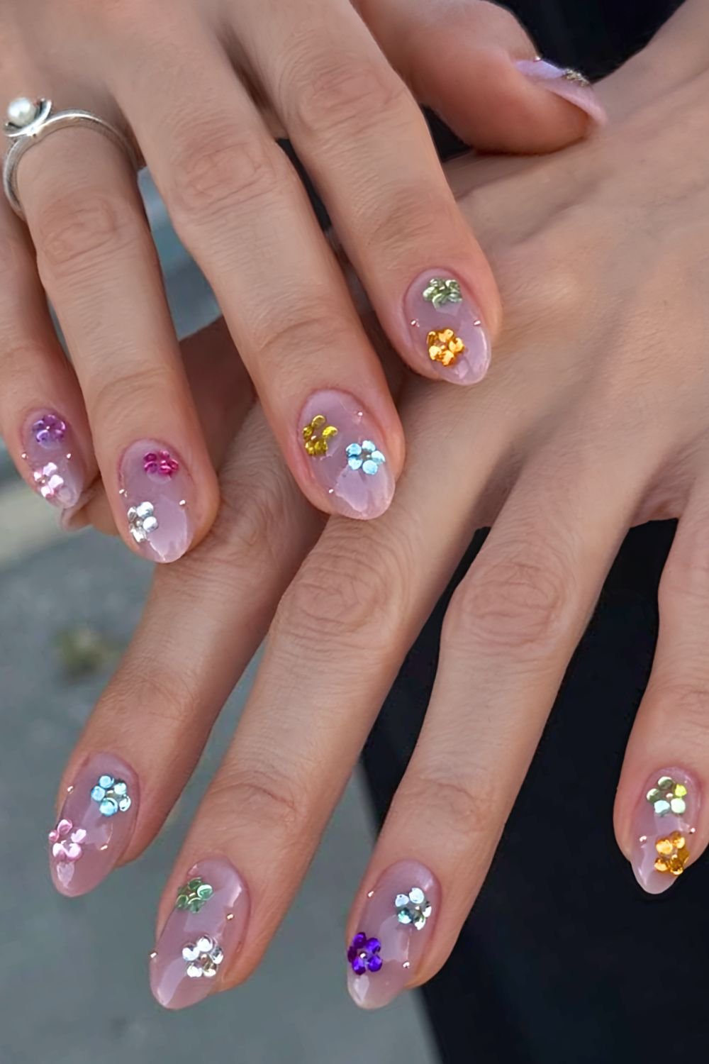Lavender gel nails with colorful gem flowers