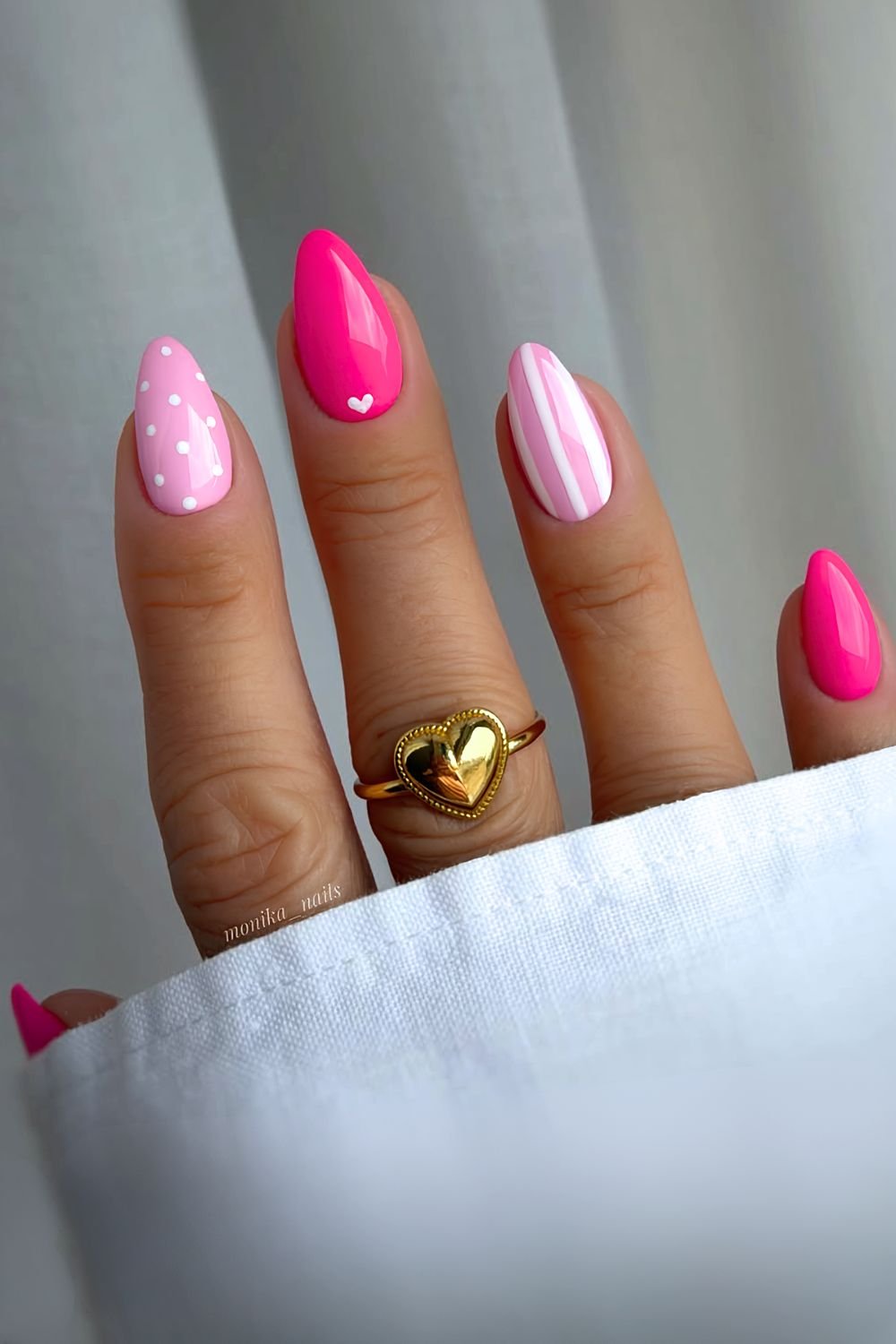 Light and hot pink nails with heart accent