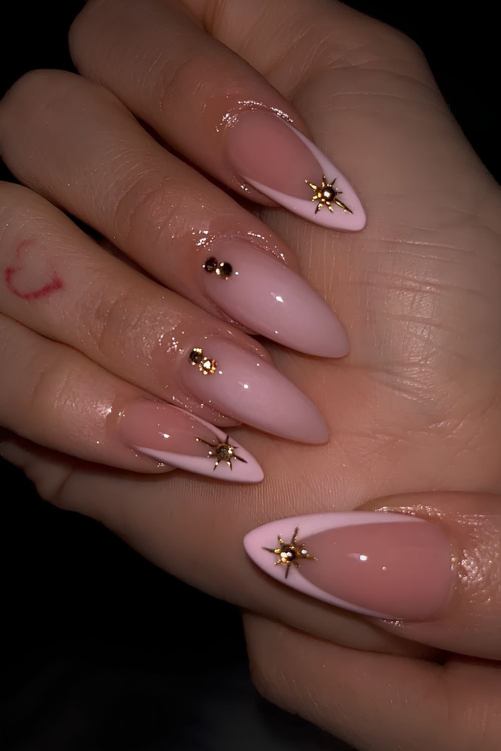 Light pink nails with gold celestial motives