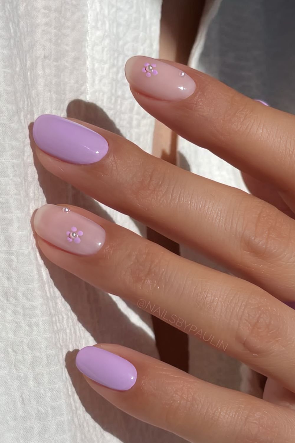 Lilac nails with pearl centered flower accents