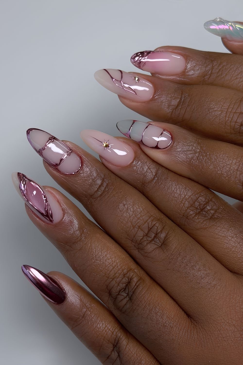 Milky pink nails with rose gold chrome design
