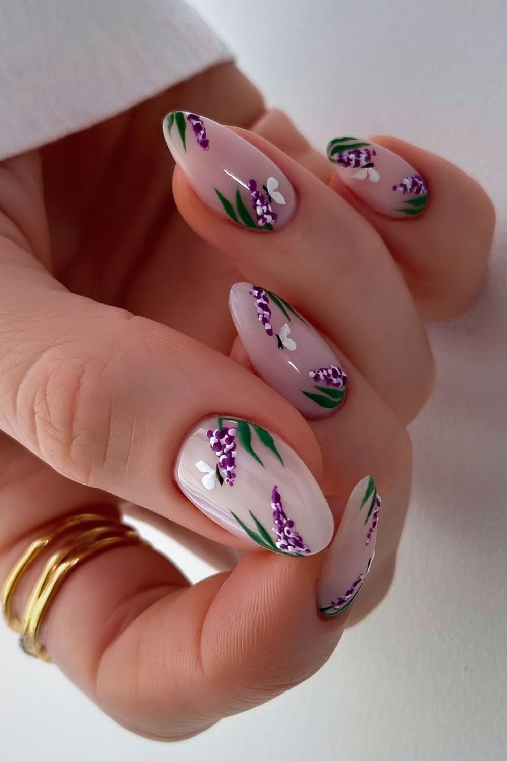 Milky white nails with purple buddleia flowers and butterfly accents