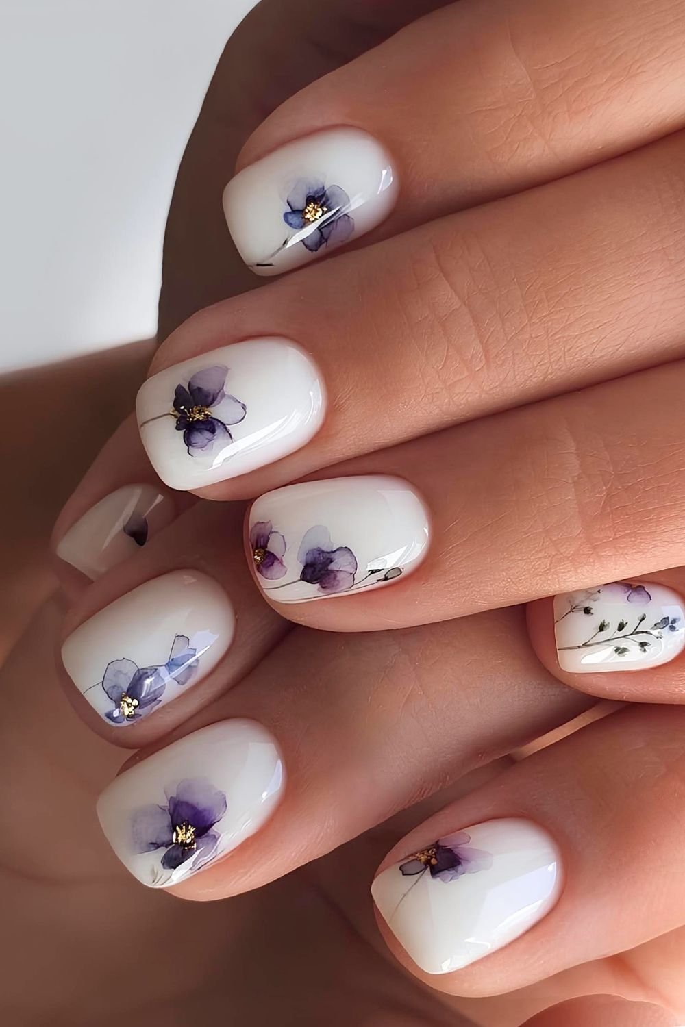 Milky white nails with purple pansies