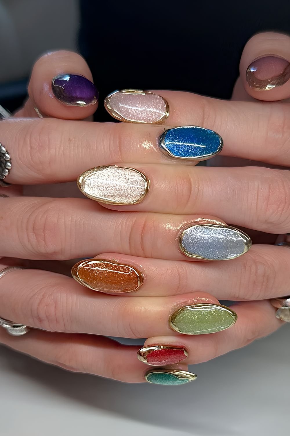 Multicolor cat-eye nails with gold drip chrome outlines