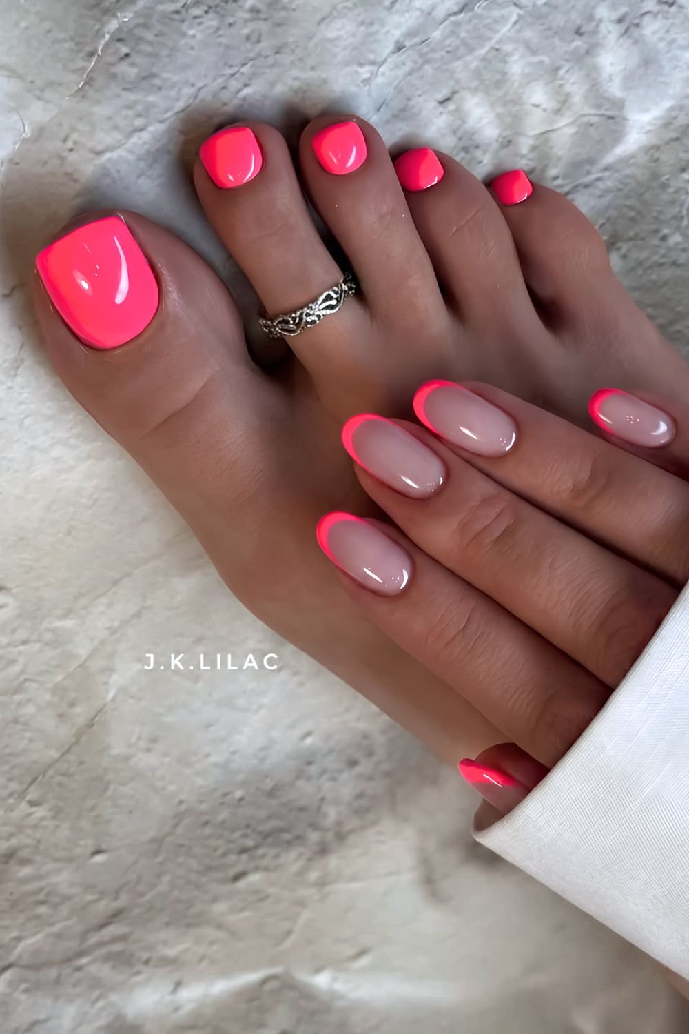 Neon pink toenails and French tip hand nails