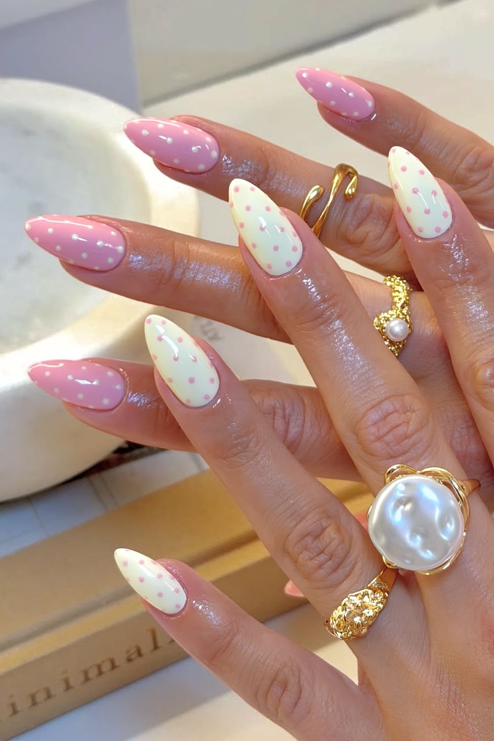 Pastel pink and yellow polka dot nails