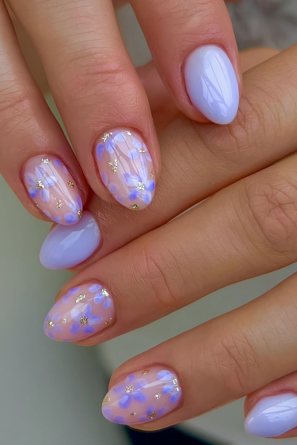 Pastel purple floral nails with gold flake centers