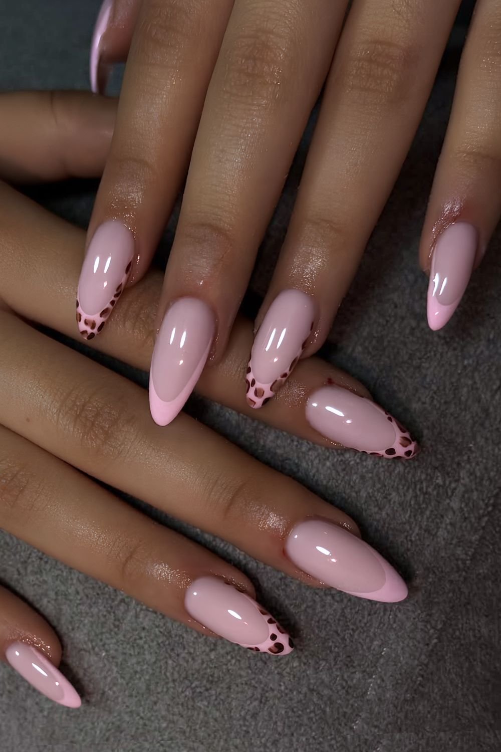 Pink French tip nails with leopard print tips accents