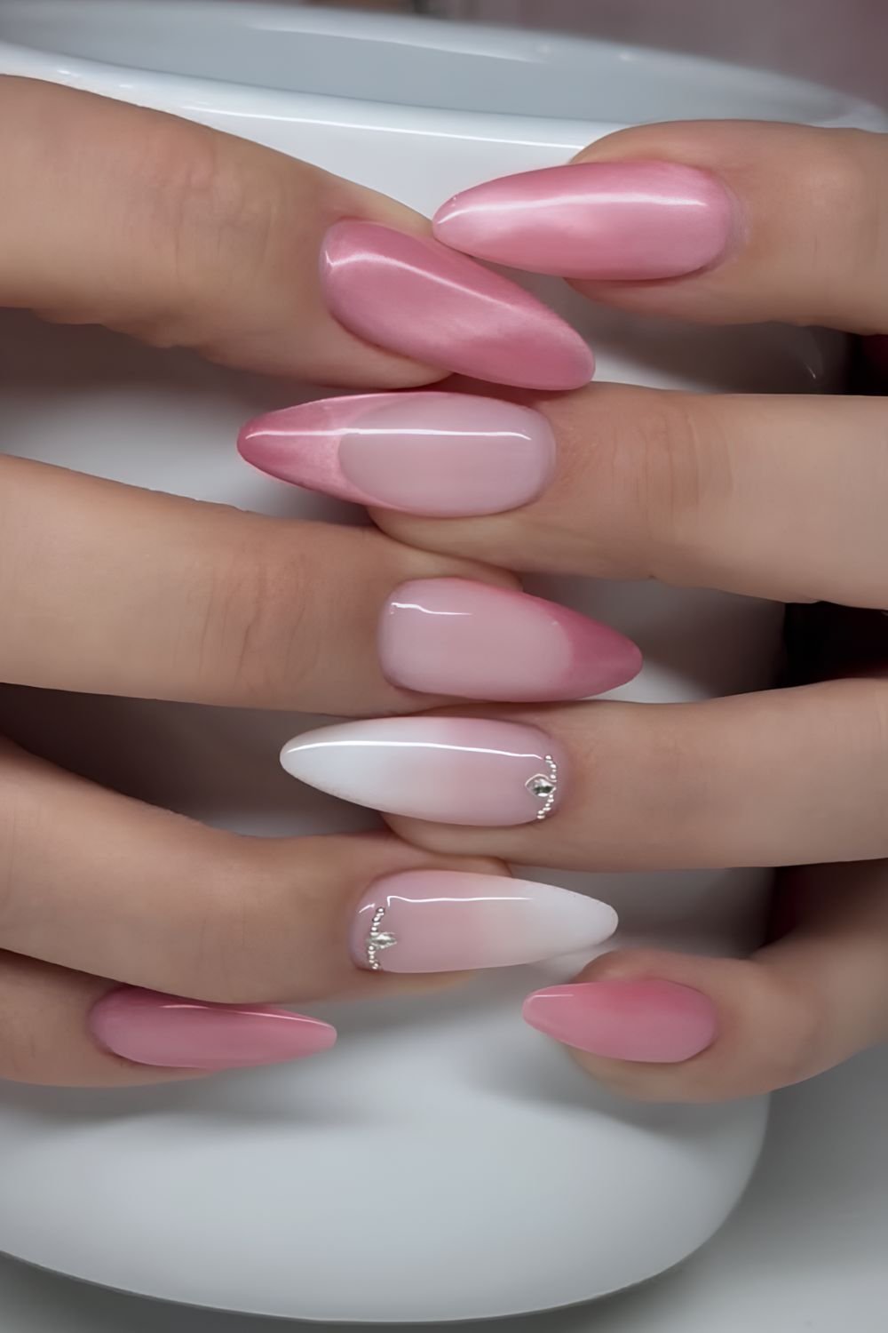 Pink cat eye nails with white ombre accents